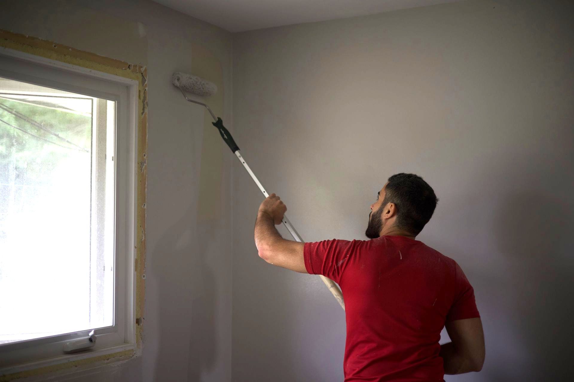 Painter rolling a fresh coat of paint